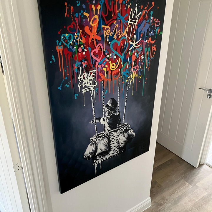 Close-up of canvas border and hanging hardware on Banksy balloon art