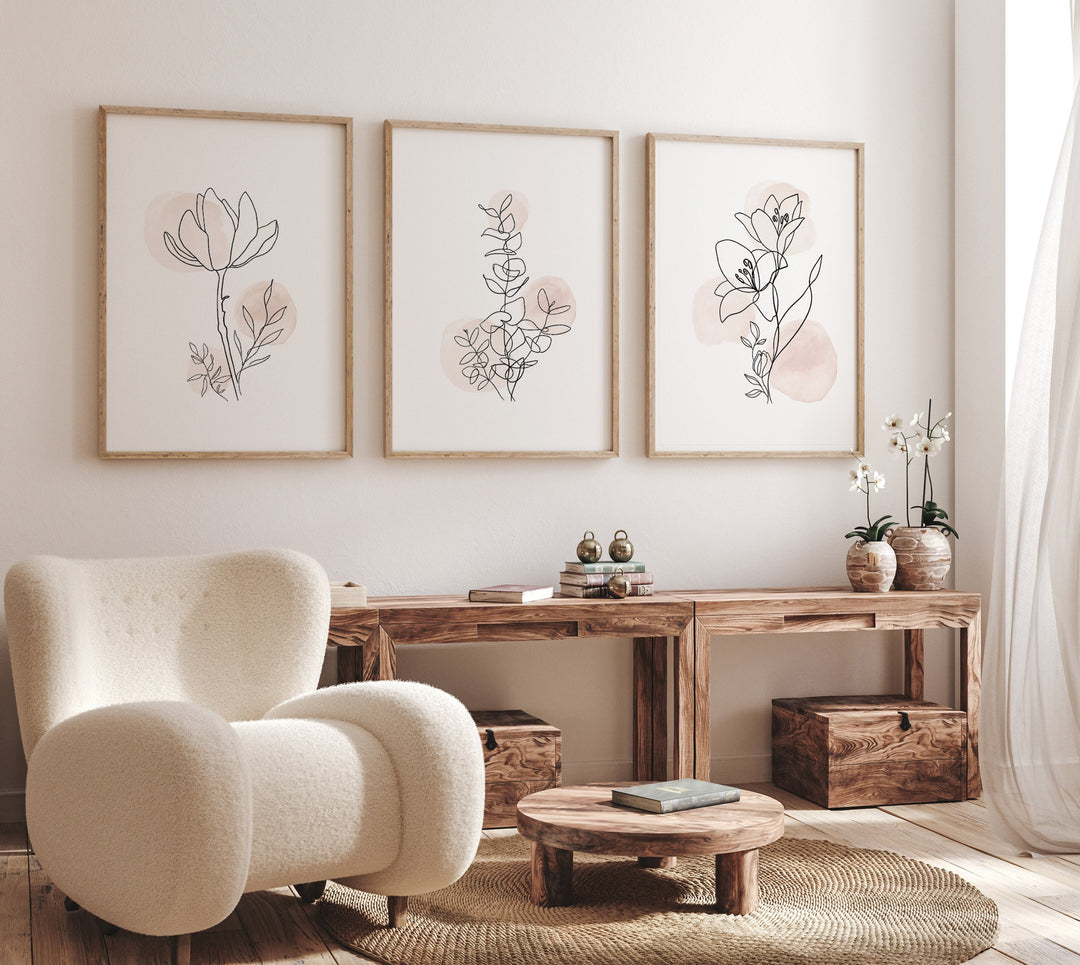 Minimalist botanical line art prints set of 3 on a neutral living room wall with blush accents