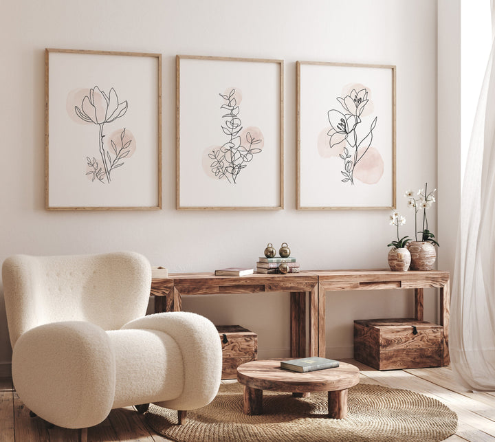 Minimalist botanical line art prints set of 3 on a neutral living room wall with blush accents