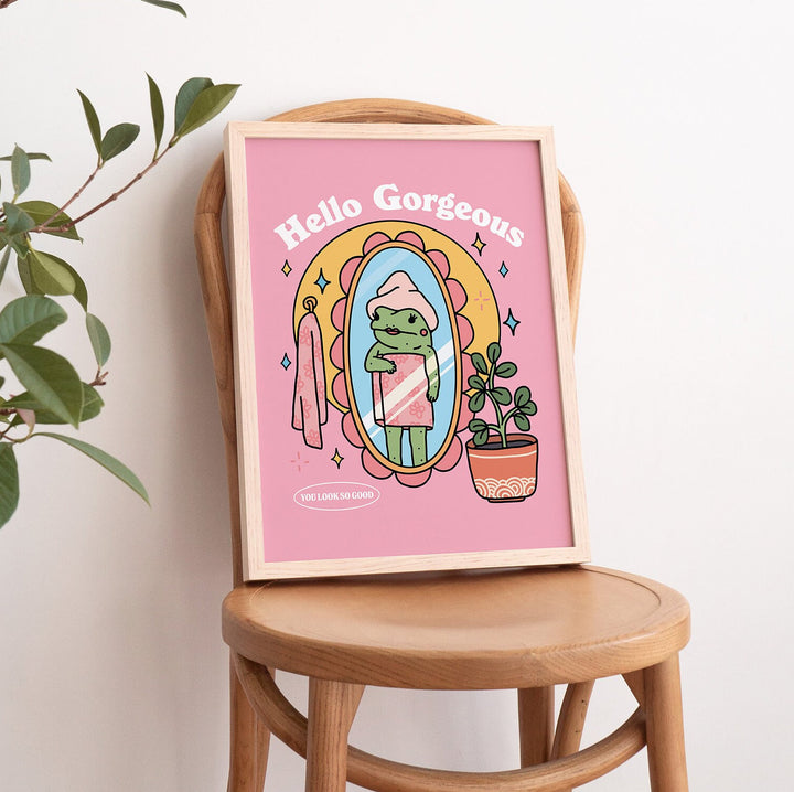 Close-up of pink frog illustration on premium paper with bold typography