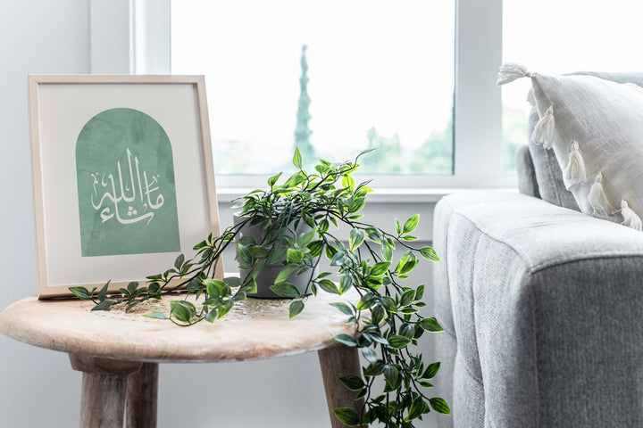 Printed wall art showcasing Arabic typography in sage tones