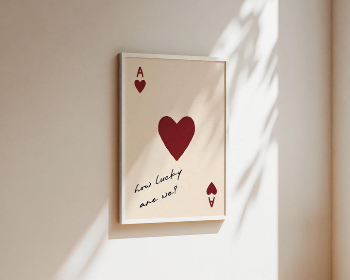 Playing card print framed and displayed on a shelf in apartment decor styling