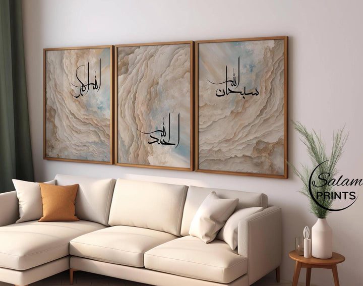 Modern abstract Islamic canvas trio displayed above a sofa with neutral tones and layered texture