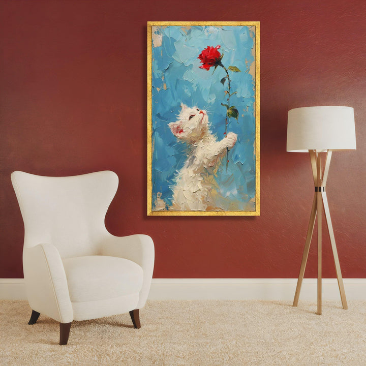 Full view of kitten portrait on blue backdrop with red rose accent