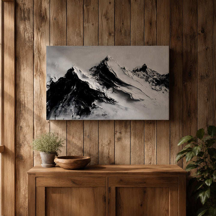 Entryway display with framed mountain landscape canvas
